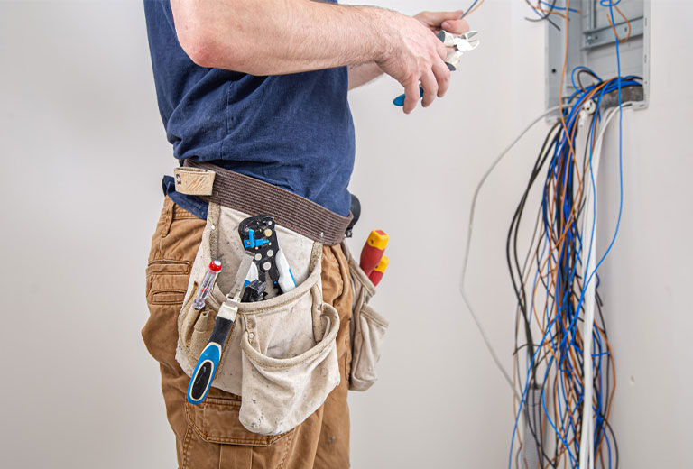 Electrician Examining the Electrical Wiring Connection