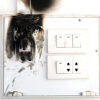 Burnt electrical outlet showing code non-compliance.