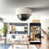 A person monitoring a CCTV camera feed on a phone.
