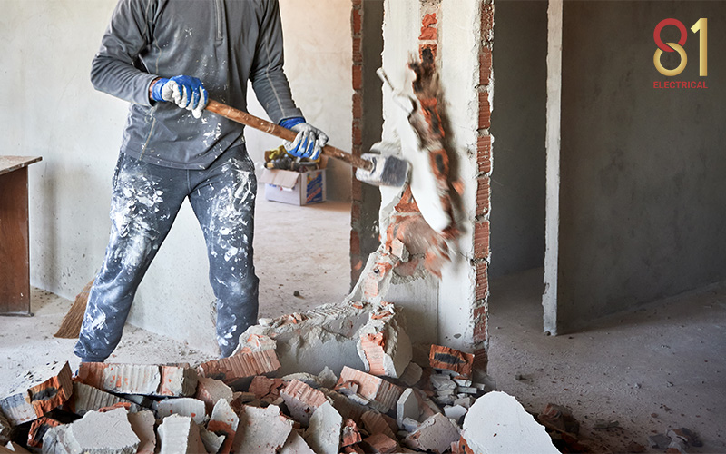 Construction worker performing wall hacking