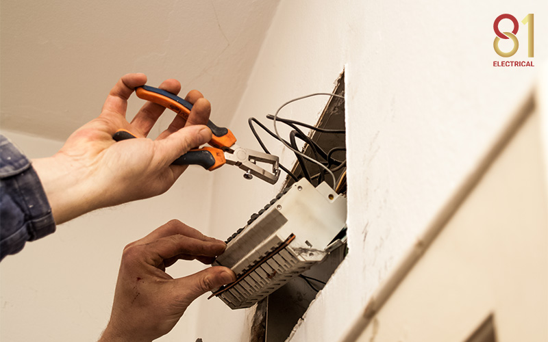 Electrician making modifications to a HDBs hidden wiring