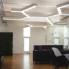 Office with hexagonal suspended light fixtures.