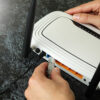 Person connecting a LAN cable to a home router.