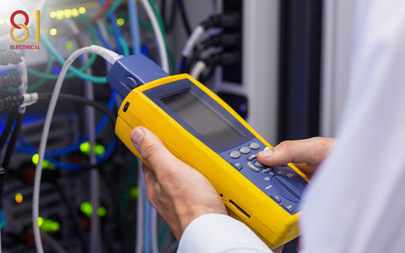 Technician using a network cable testing tool.