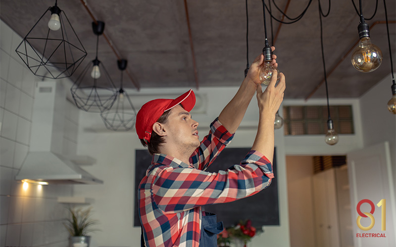 An electrician inspecting a light source
