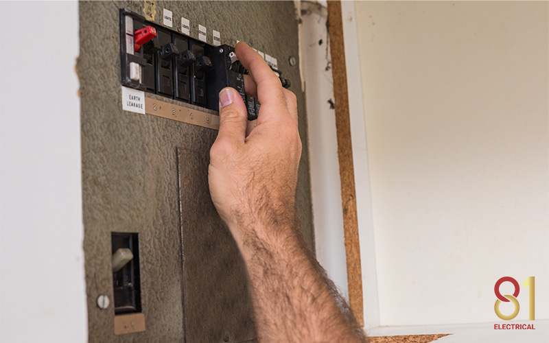 Electrician handling a circuit breaker