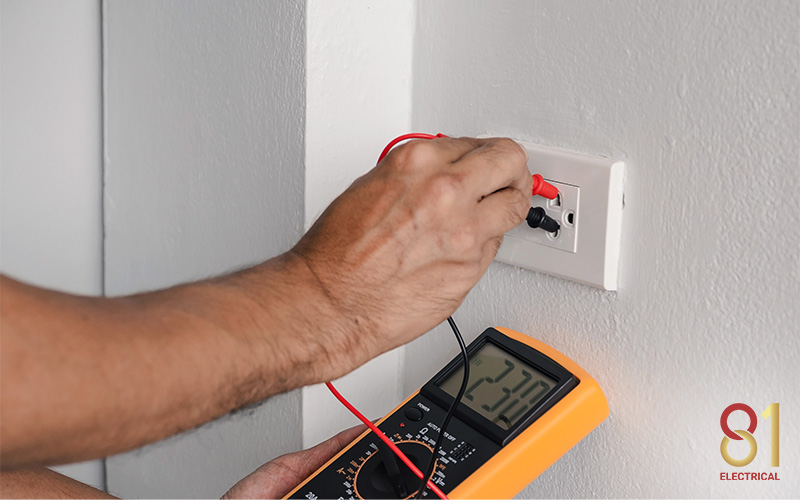 Electrician testing the new light switch button after installation